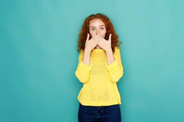 scared woman covering mouth with hands - silence finger on lips businesswoman one person imagens e fotografias de stock