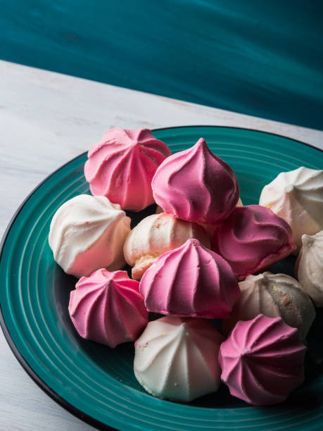 istock Pastel color meringue on green 853808456