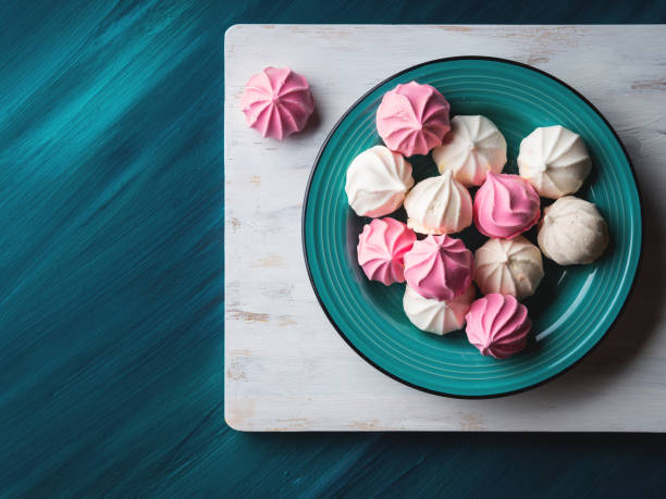 istock Pastel color meringue on green 853808738