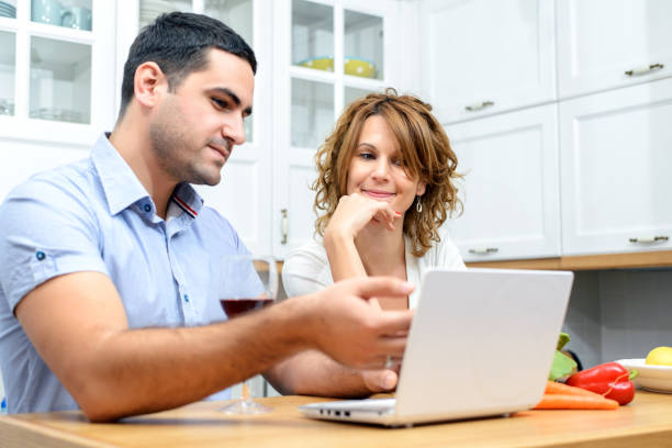 istock Couple in modern kitchen working and preparing a meal 853808888