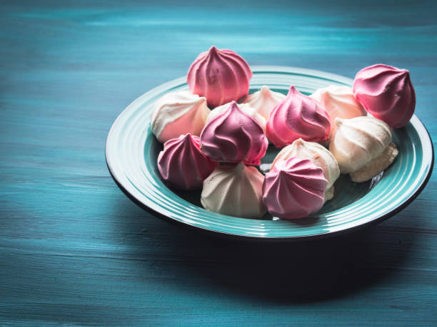 istock Pastel color meringue on green 853808980
