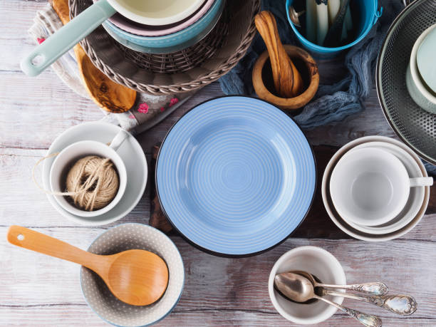istock Ceramic and enamel crockery on wooden background 853812710