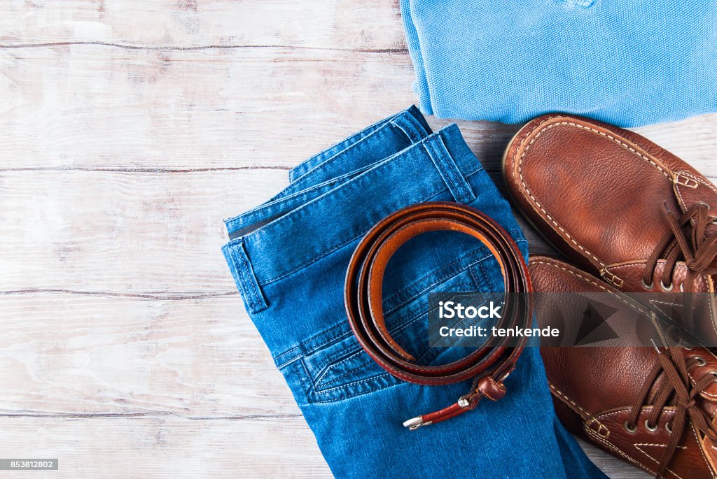 Man's clothes lifestyle shoes flat lay Man's clothes flat lay with blue jeans, T-shirt, pullover, leather shoes and belt Adult Stock Photo