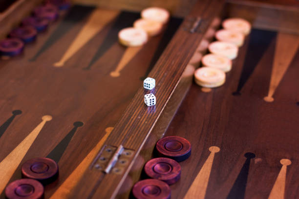 Backgammon board with dice and checkers on triangles