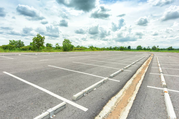 istock Empty parking lot against a beautiful blue sky 853817722