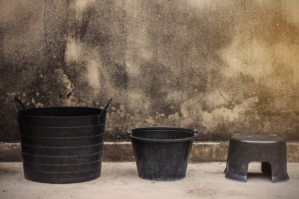 istock Buckets and plastic chairs at a walls. 853824040