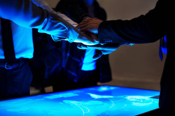 istock Hands join at cyber space tablein a meeting 853828806