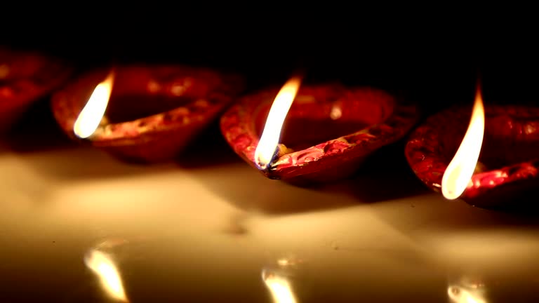 Group of oil lamps illuminated at night.