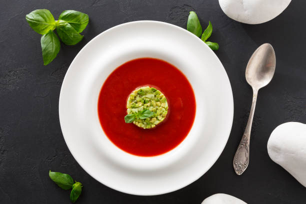 istock Cold tomato soup gazpacho with avocado top view 853832252