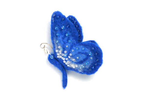handmade brooch from felt in the form of a blue butterfly, decorated with beads on a white background - felt arts and entertainment concepts and ideas isolated on white imagens e fotografias de stock