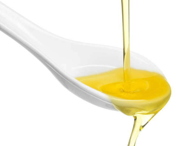 istock olive oil overflowing from a spoon 853834116