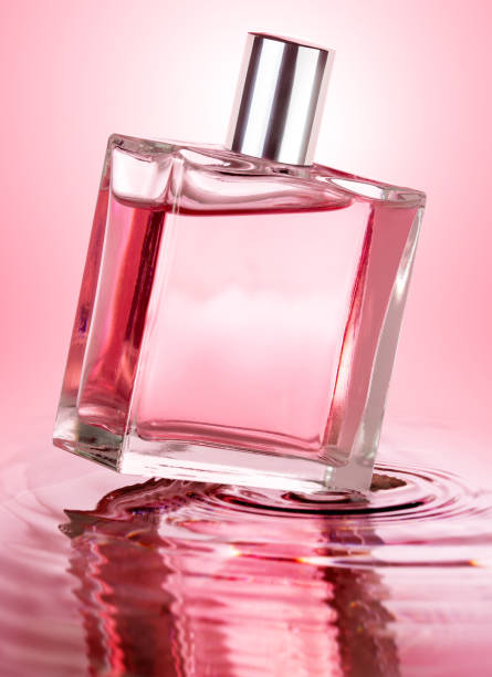 istock pink perfume bottle on rippled water 853834182