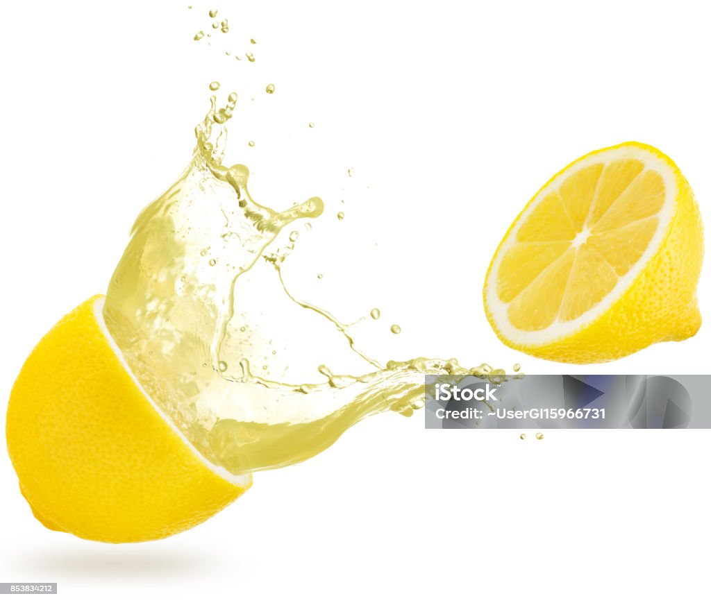 juice spilling out of a lemon yellow liquid spilling out of half lemon isolated on white Lemon - Fruit Stock Photo