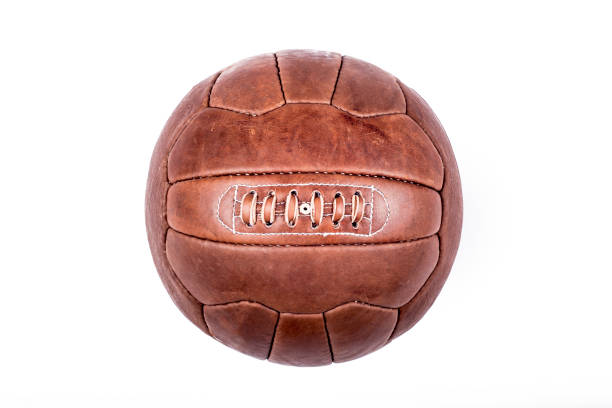 Close up portrait style shot of a soccer ball, with a few nicks and scratches on it.