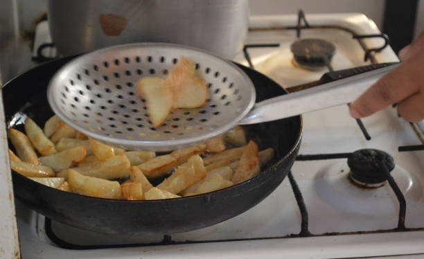 istock Fry potatoes in a frying pan on a gas cooker 853844816