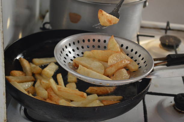 istock Fry potatoes in a frying pan on a gas cooker 853844944