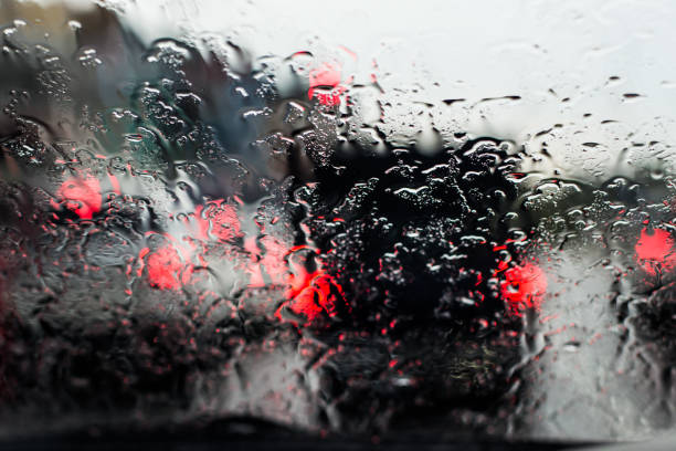 istock rain droops with blurred lights from the car 853847288