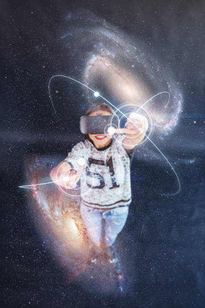 istock Young beautiful girl gets positive emotions using virtual reality goggles. A woman examines star via Augmented Reality. 853847926