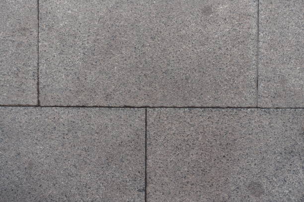 istock Closeup of pavement made of grey granite blocks 853849254