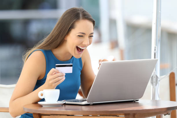 istock Excited woman paying on line with a credit card 853858832