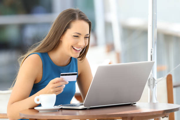 istock Happy woman paying on line with a credit card 853858866