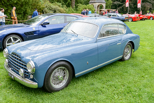 Ferrari 195 Inter Ghia Berlinetta GT coupe car. The 195 Inter was produced in 1950 and there were only 27 made. The car is on display during the 2017 Classic Days event at Schloss Dyck. People in the backgroudn are looking at the cars.
