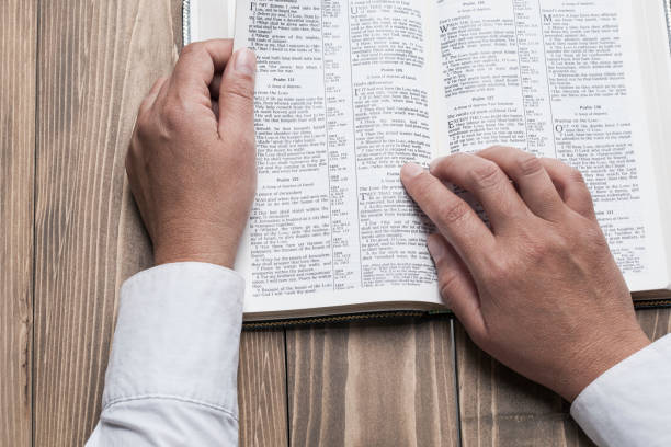 istock Woman hands and Holy Bible 853860264
