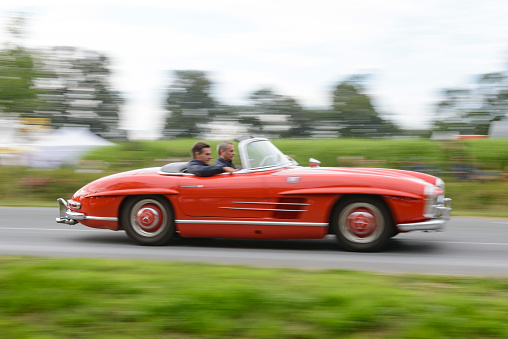 Mercedes-Benz 300SL Roadster convertible classic sports car driving at high speed. The Mercedes-Benz 300 SL (W198) was the fastest production car of the 1950s. The car is on display during the 2017 Classic Days event at Schloss Dyck
