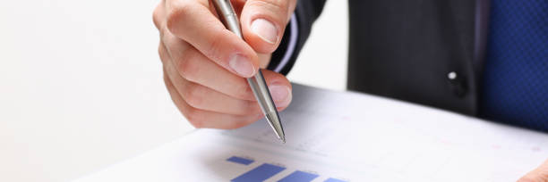 istock Male hand holding silver pen 853864090