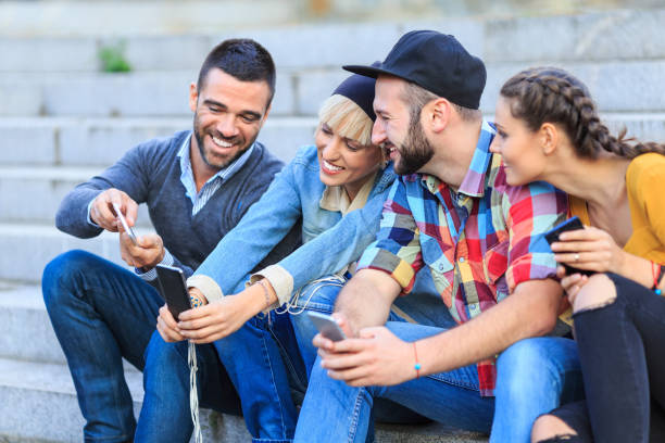 istock Friends sitting and using smart phones 853867848