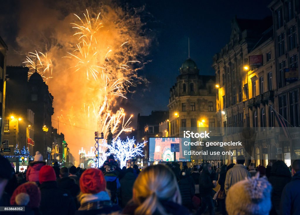 Winter fireworks on George Street in Edinburgh Edinburgh, Scotland, UK - People watching festive lights and fireworks on George Street in central Edinburgh, during the city's annual winter festival in celebration of Christmas and Hogmanay. Edinburgh - Scotland Stock Photo