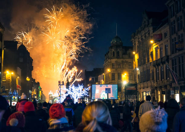 Winter fireworks on George Street in Edinburgh Edinburgh, Scotland, UK - People watching festive lights and fireworks on George Street in central Edinburgh, during the city's annual winter festival in celebration of Christmas and Hogmanay. hogmanay photos stock pictures, royalty-free photos & images