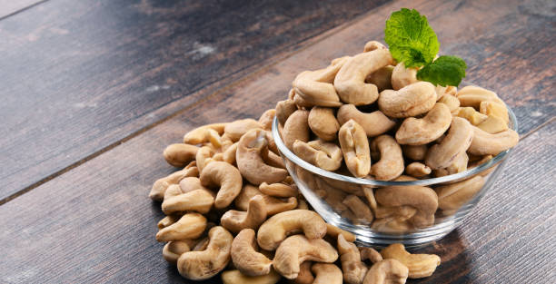 istock Bowl with cashew nuts on wooden table 853872168