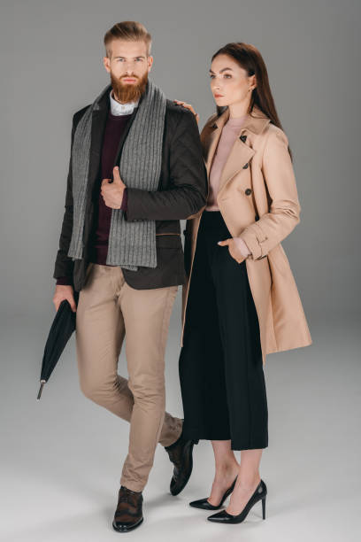 istock fashionable couple with umbrella 853877412