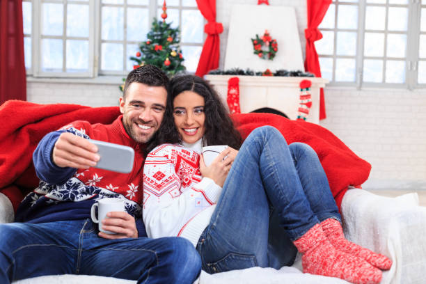 istock Couple taking christmas selfie at home 853877726