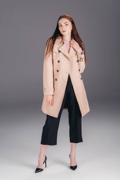 istock fashionable young woman in coat 853878052