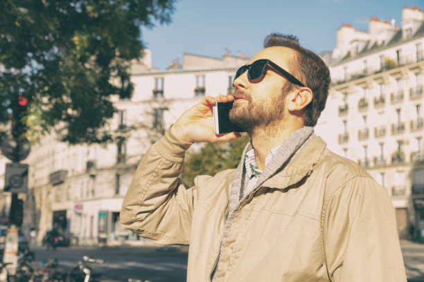 istock Modern guy using cellphone in the European city. 853879366