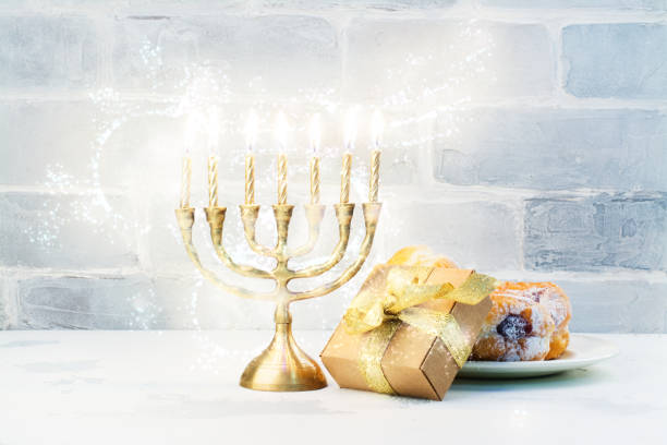 istock Happy Hanukkah background with menorah, burning candles and donu 853879640