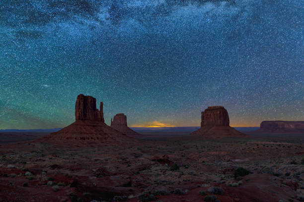 Night sky with stars above Monument Valley, Arizona. A view on night sky with stars above silhouette of the Monument Valley at night in Navajo tribal park, Utah - Arizona, USA. monument valley stock pictures, royalty-free photos & images