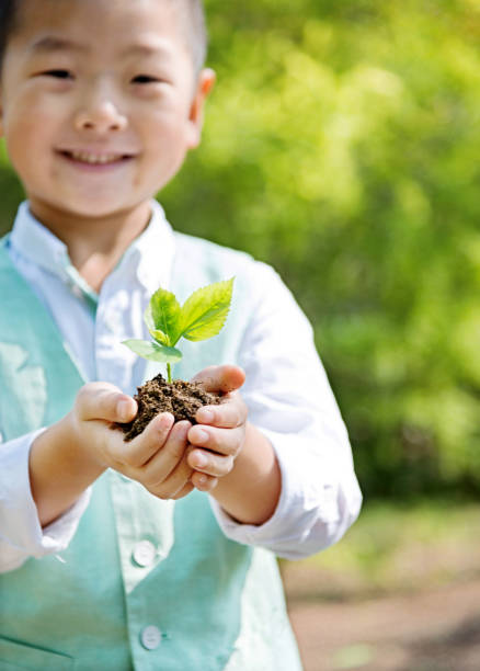 istock Littel boy holding plant 853882936
