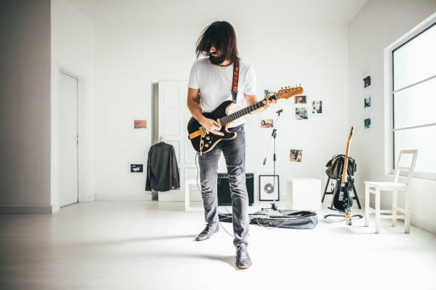 Man playing guitar for his own