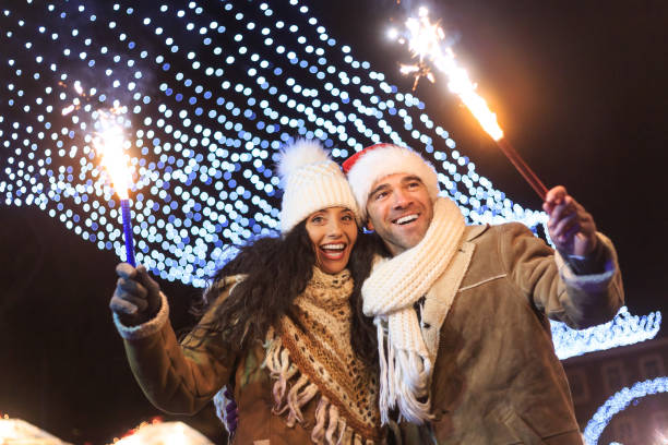 istock Young couple having fun with sparkling candles at night 853886918