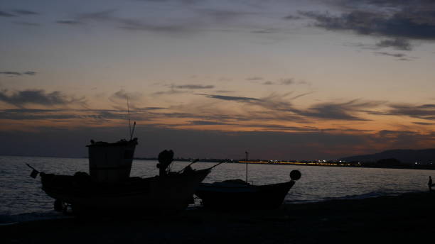istock sunset beach fishermen boats 853887312