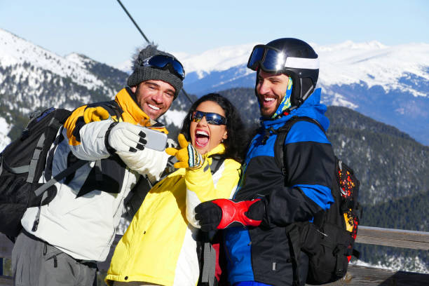istock Three happy friends taking selfie on the mountain peak 853888154