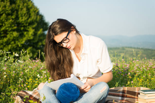 istock Beautiful young brunette sitting outdoors 853888244