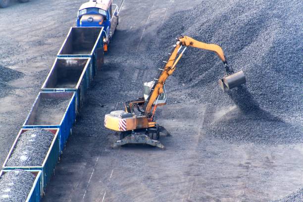 istock Work in port coal transshipment terminal. Coal unloading of wagons with special cranes. Working in a port near the Baltic Sea. 853898228