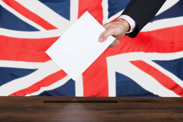 istock Businessperson Putting Vote Into Ballot Box 853899568