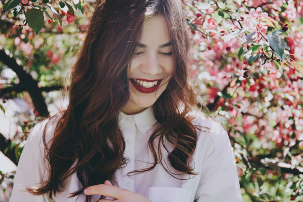 istock Smiling girl by the blossoming tree. 853899594