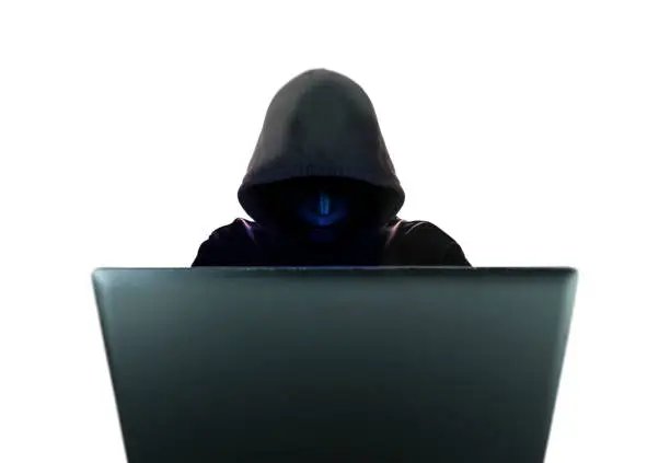 Computer hacker in black mask and hood isolated on white background