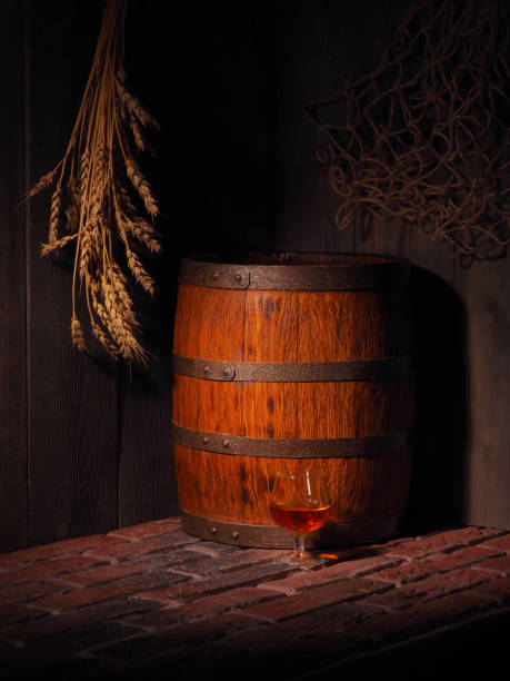 istock Glass of cognac with barrel in cozy cellar 853902172